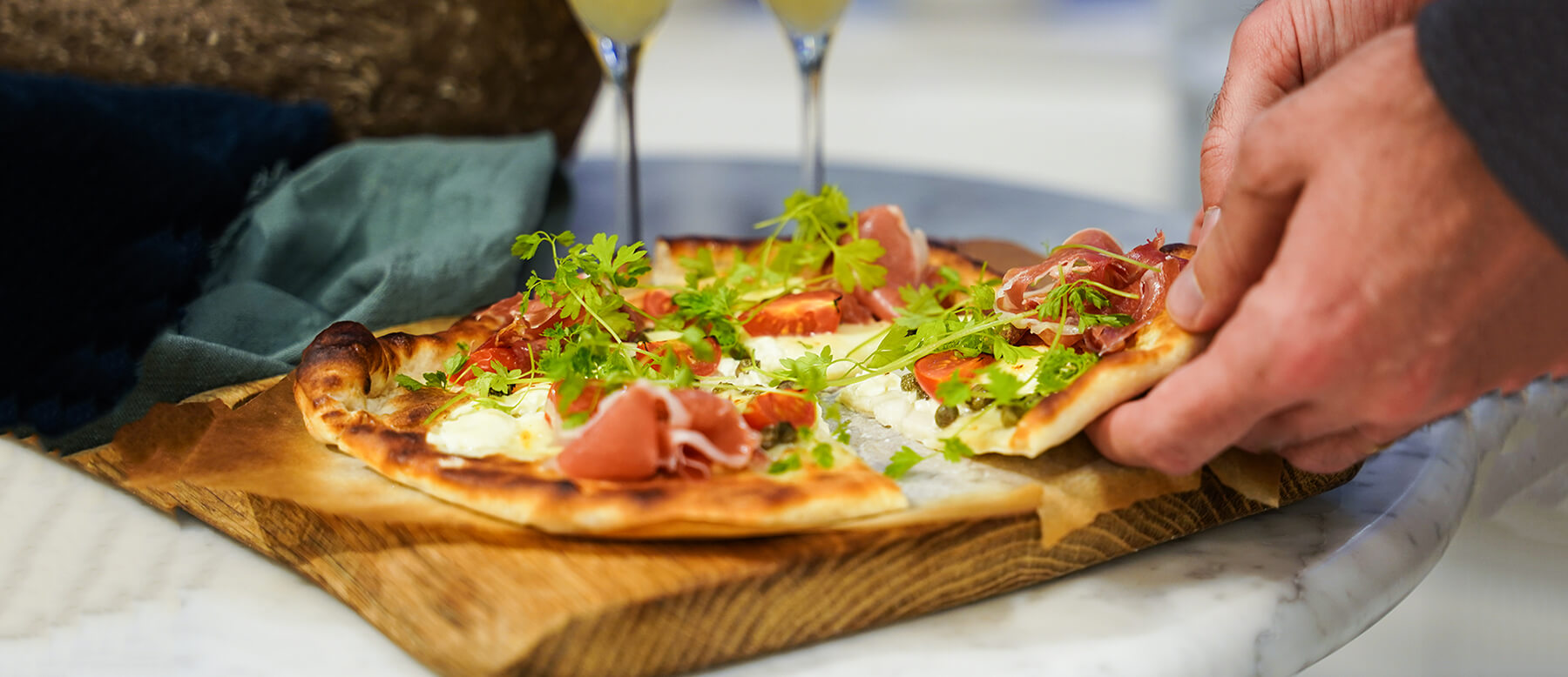 Pizza bianco med kapris, körsbärstomat, serrano-skinka, crème fraiche, buffelmozzarella och körvel